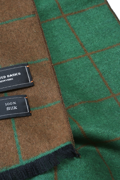 Close-up of green and brown fabric with silk label