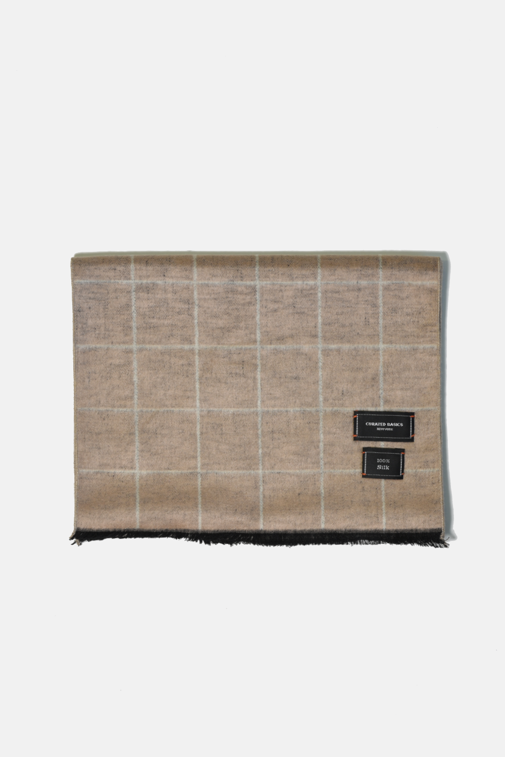 Plaid blanket with a brand label on a white background